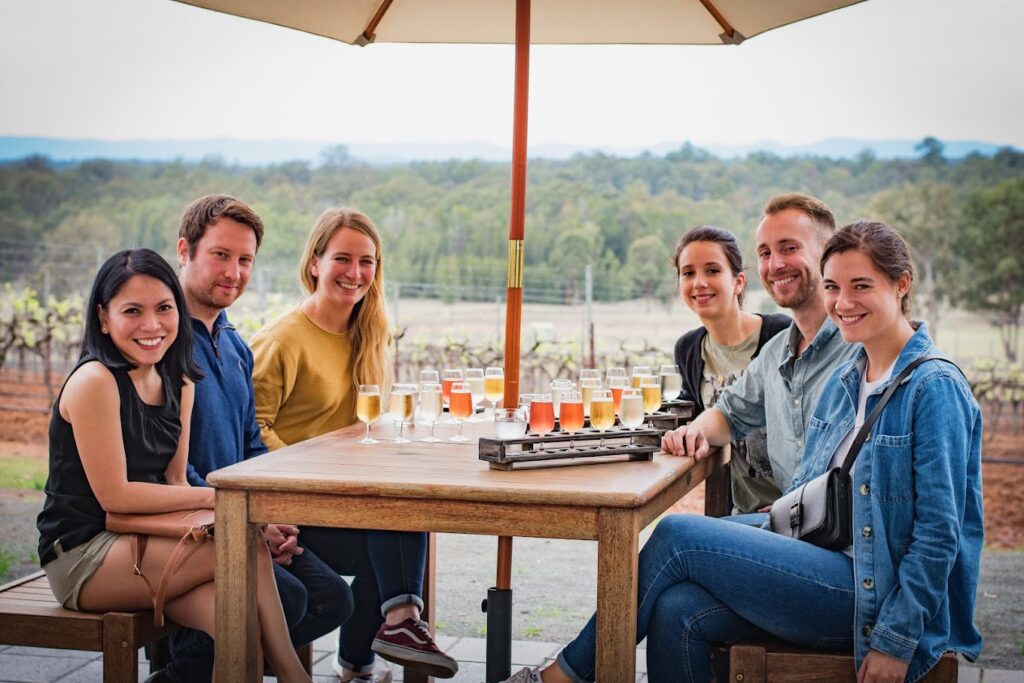 group sitting at a table at pokolbin cider house hunter valley